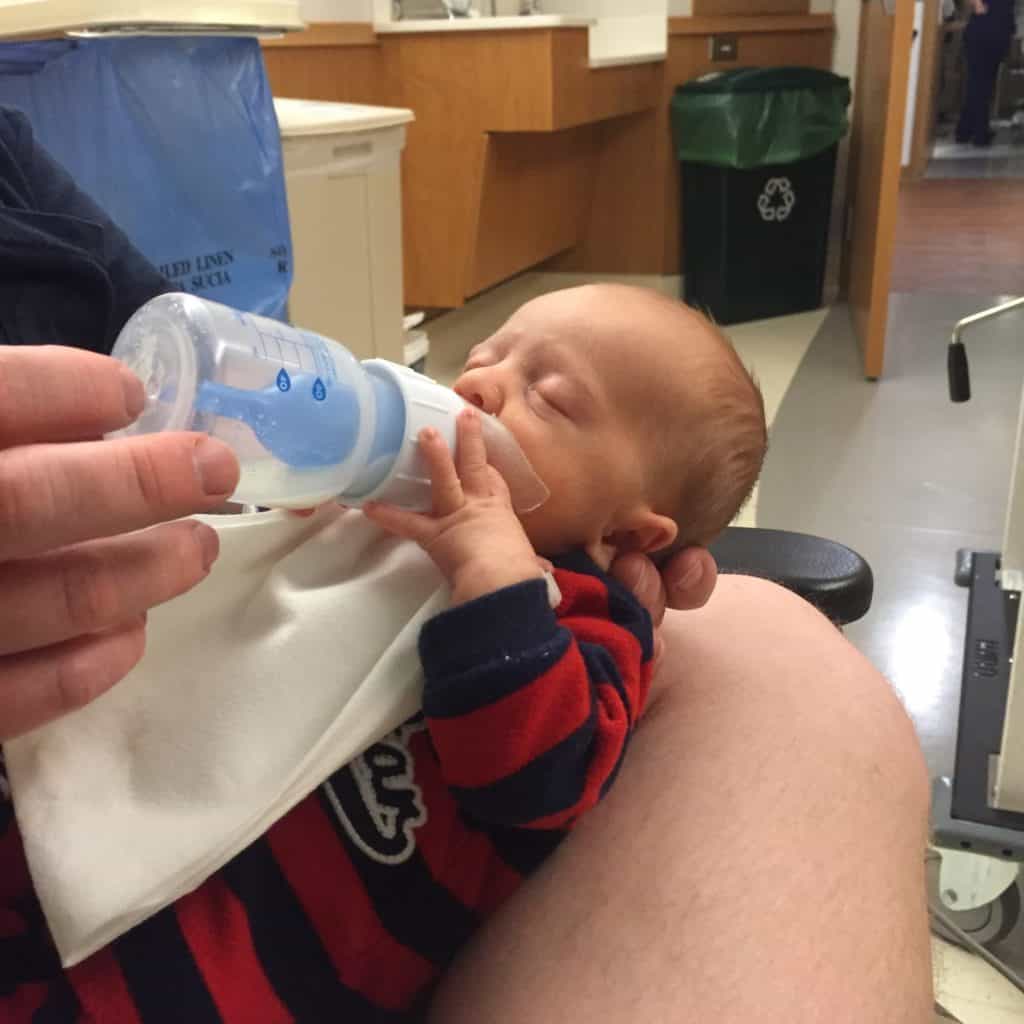 Tiny baby drinking from a Doctor Brown's Bottle in the nicu eating his mother's expressed breast milk Dr. Brown's Bottles in the NICU