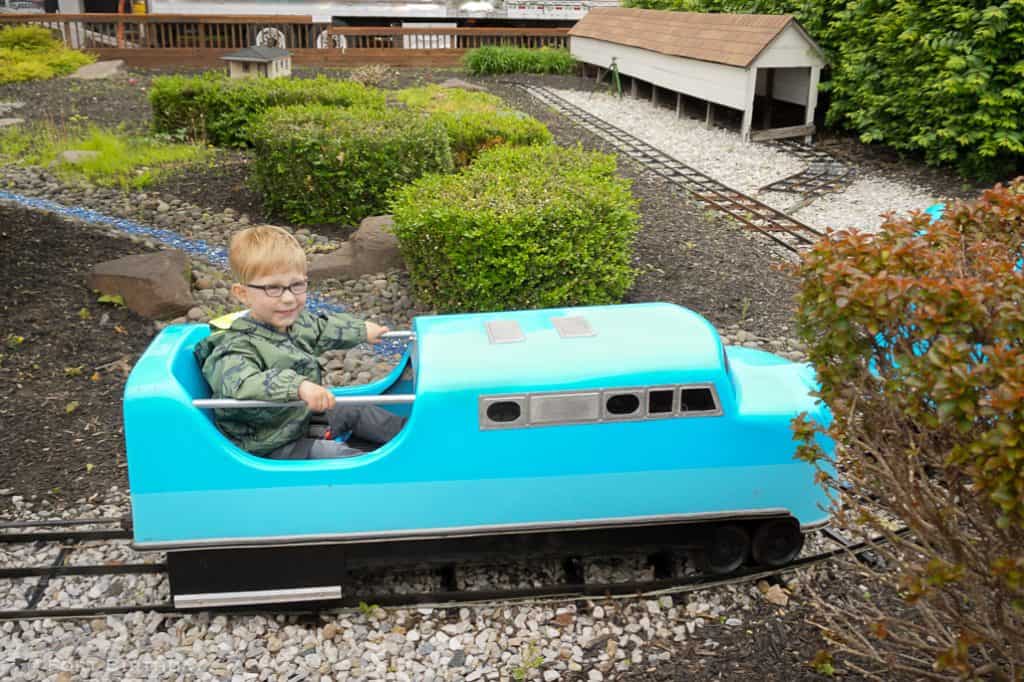 Smiling toddler boy rides G scale train at B&O railroad museum