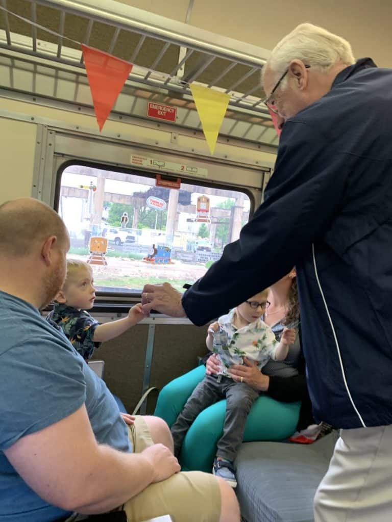 Twin boys getting their tickets punched by the conductor at A Day out With Thomas