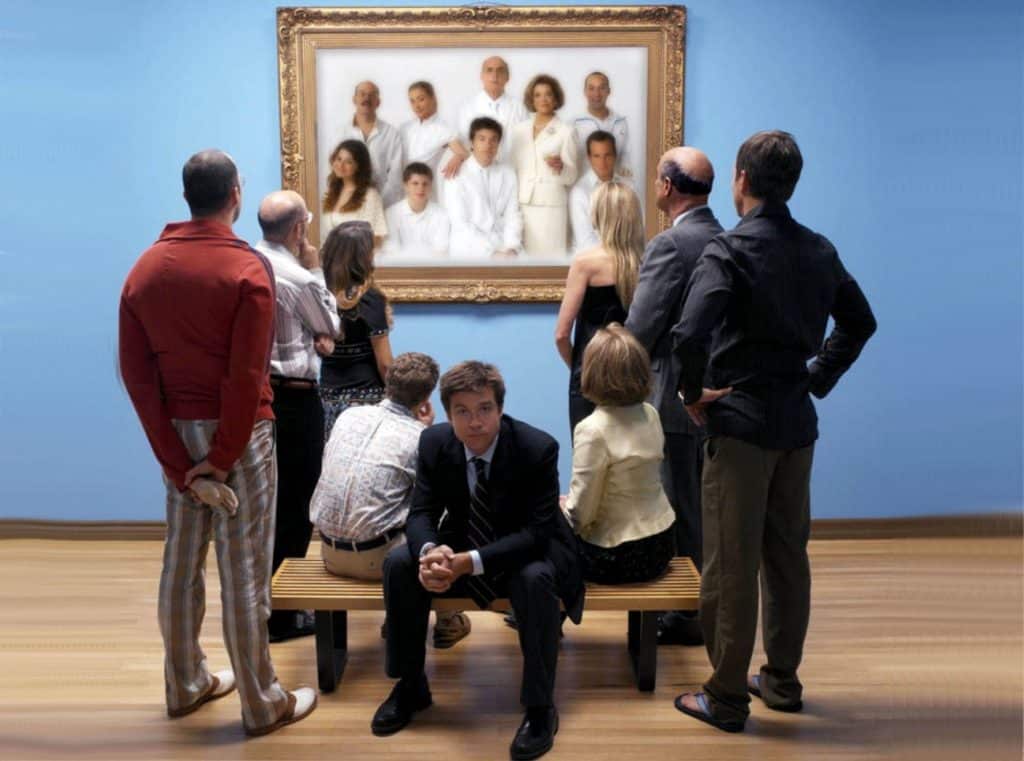 Bluth family looking at their family portrait with Michael Bluth looking into camera