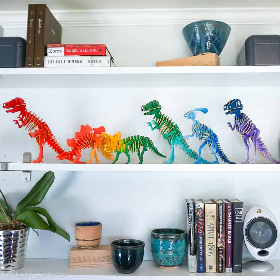 Rainbow colored Dinosaur 3 D puzzles on a shelf
